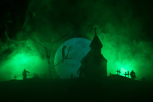 Spooky graveyard covered in a green smoky atmosphere, a church in the middle, and a giant full moon in the background