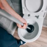 cropped-shot-of-male-plumber-using-plunger-and-cle-2023-11-27-05-06-26-utc_720