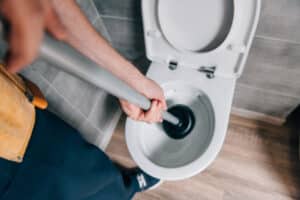 cropped-shot-of-male-plumber-using-plunger-and-cle-2023-11-27-05-06-26-utc_720